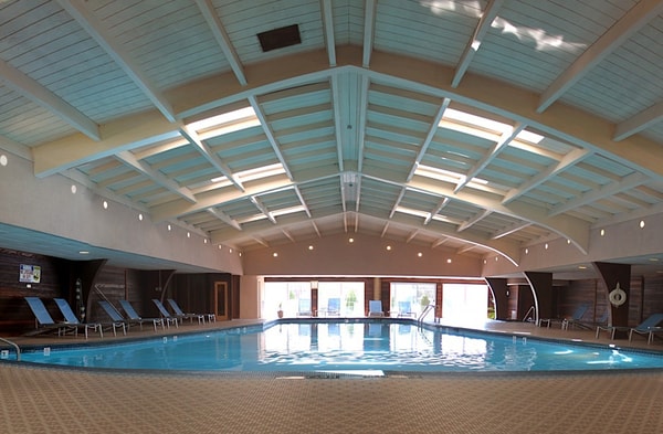 Largest indoor swimming pool in Ann Arbor with dry sauna and whirlpool, along with an outdoor patio for relaxation. 